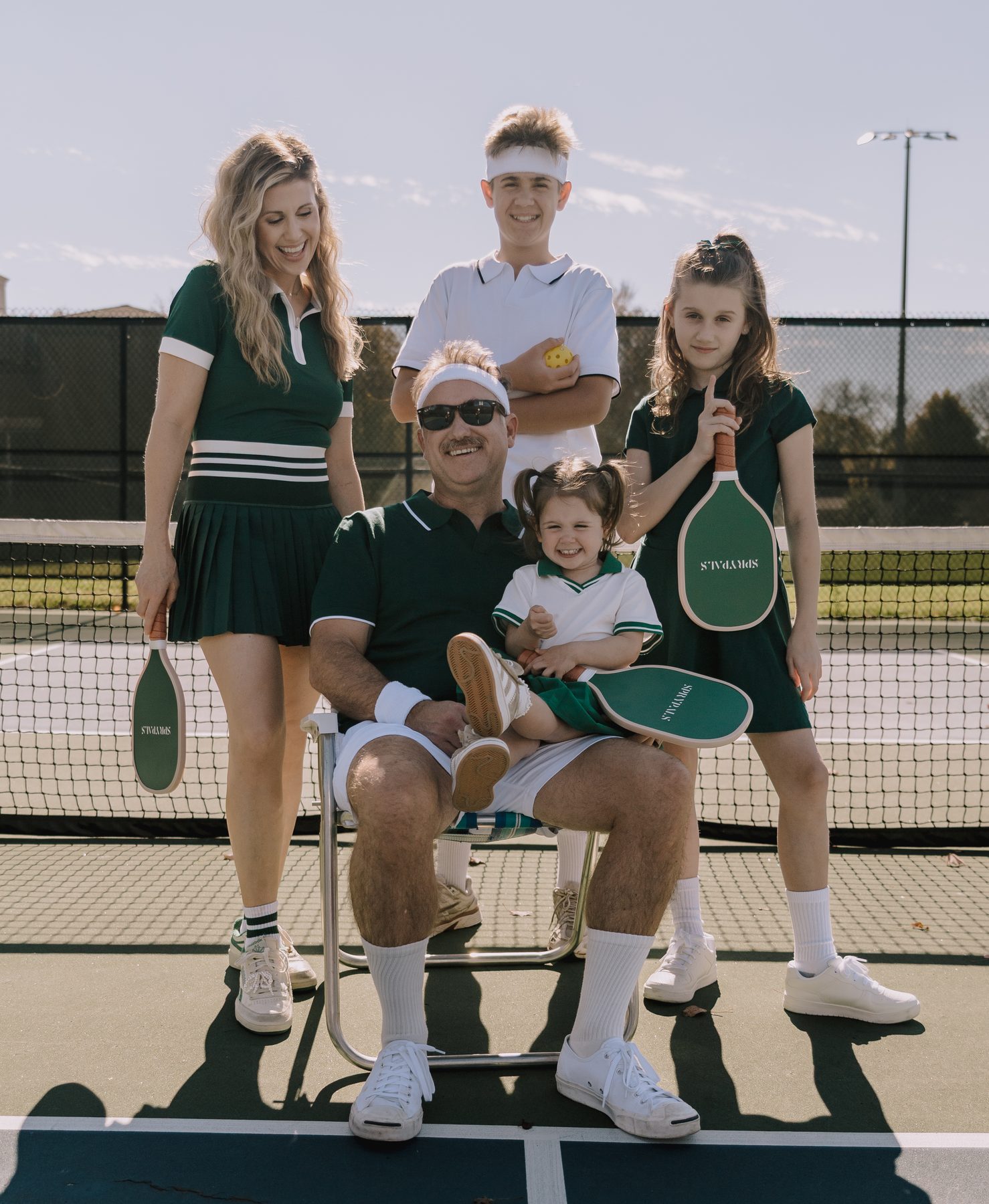 Joe, Kristin and their three kids on a pickleball court